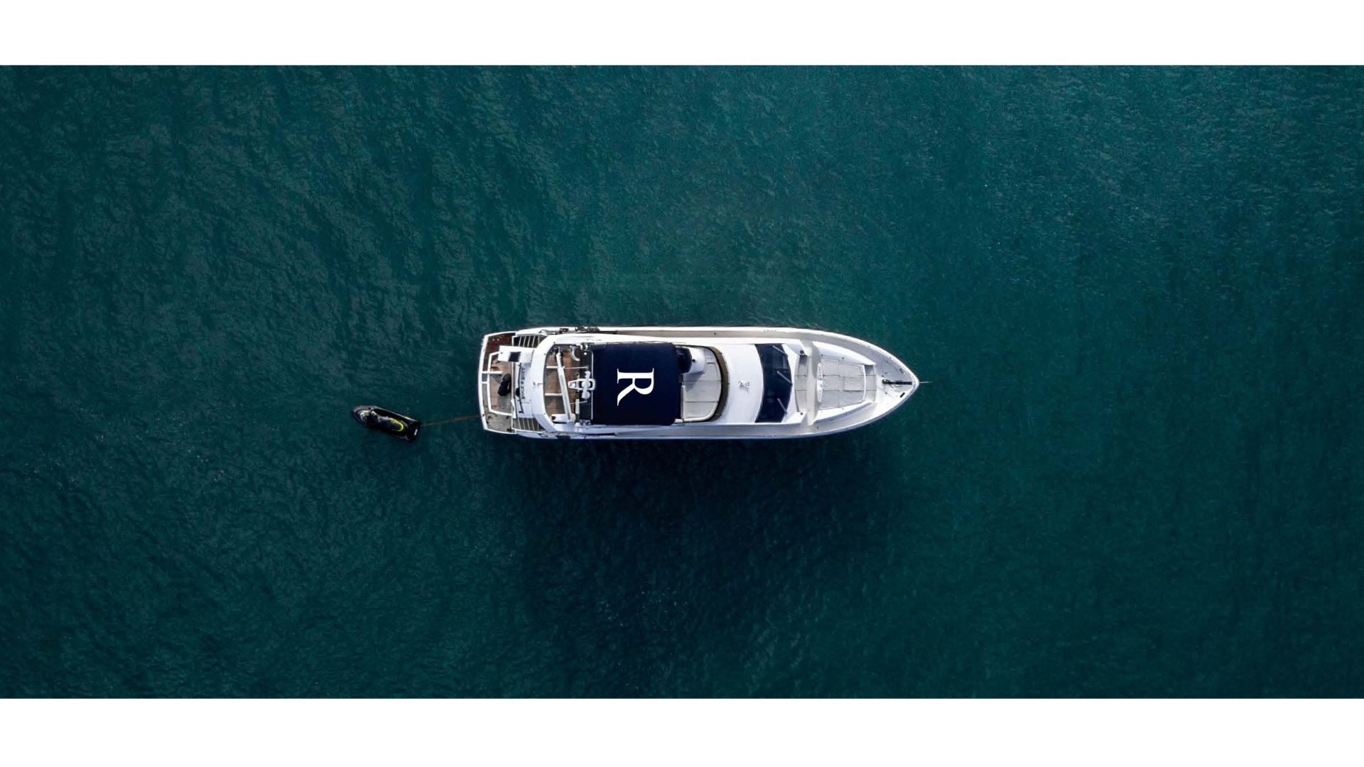 RESIDENT&trade; Media: aerial view of luxury yacht on turquoise water